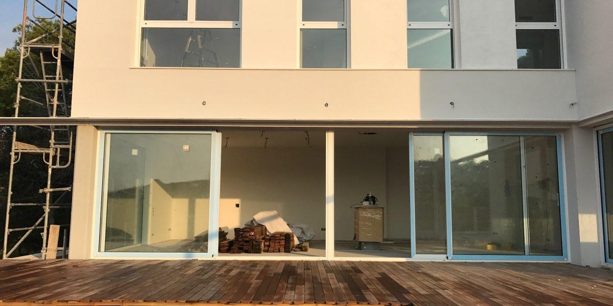 Trabajadores instalando Puertas Correderas en una casa que se encuentra en proceso de obras